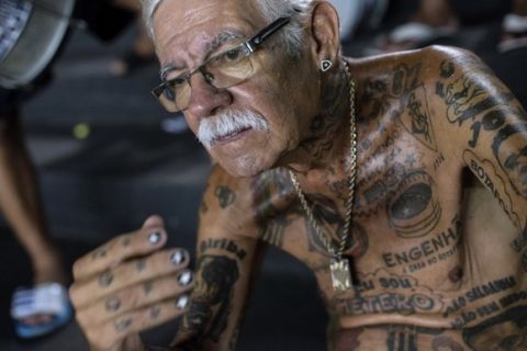TO GO WITH AFP STORY by Javier Tovar
Brazilian football club Botafogo fan Delneri Martins Viana, a 69-year-old retired soldier, attends a team's match at Sao Genario stadium in Rio de Janeiro, Brazil, on January 21, 2014. Delneri has 83 tattoos on his body dedicated to Botafogo and describes himself as the club's biggest fan.   AFP PHOTO / YASUYOSHI CHIBA