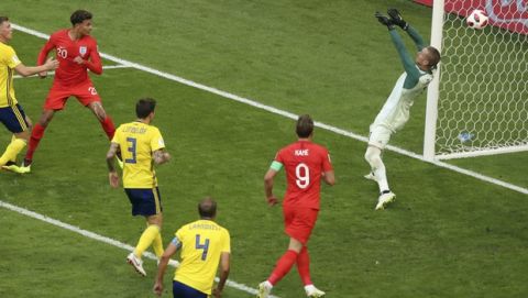 England's Dele Alli, 2nd left, scores his side's second goal during the quarterfinal match between Sweden and England at the 2018 soccer World Cup in the Samara Arena, in Samara, Russia, Saturday, July 7, 2018. (AP Photo/Thanassis Stavrakis)
