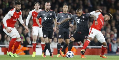 Arsenal's Alex Oxlade-Chamberlain, right, is challenged by Bayern's Arturo Vidal during the Champions League round of 16 second leg soccer match between Arsenal and Bayern Munich at the Emirates Stadium in London, Tuesday, March 7, 2017. (AP Photo/Frank Augstein)