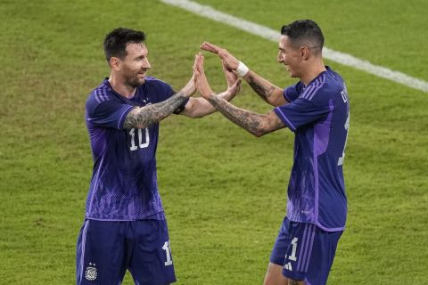 Argentina's Lionel Messi, left, and Angel Di Maria celebrate after a goal during a friendly match between Argentina and United Arab Emirates in Abu Dhabi, Wednesday, Nov. 16, 2022. (AP Photo/Hussein Malla)
