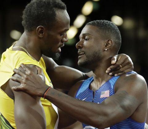 Gold medal winner United States' Justin Gatlin, right, embraces Jamaica's Usain Bolt who won bronze after the men's 100m final during the World Athletics Championships in London Saturday, Aug. 5, 2017. (AP Photo/Matt Dunham)