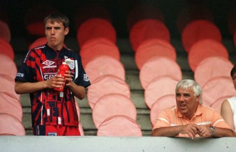 Phil Neville watches the England training with his father Neville Neville