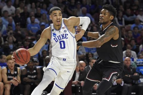 Duke's Jayson Tatum, left, drives past South Carolina's Chris Silva, right, during the first half in a second-round game of the NCAA men's college basketball tournament in Greenville, S.C., Sunday, March 19, 2017. (AP Photo/Rainier Ehrhardt)