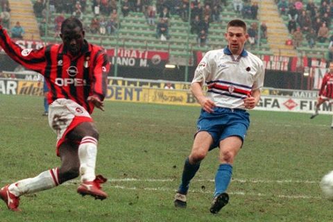 AC Milan Liberian-born forward George Weah scores the first of his two goals, as an unidentified defender of Sampdoria looks on, during this Italian major league match at Milan's San Siro stadium Sunday, February 2, 1997. Notwithstanding Weah two goals, Milan lost 3-2 to Sampdoria. (AP Photo/Carlo Fumagalli)