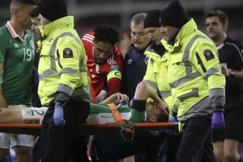 Ireland's Seamus Coleman is taken off the pitch injured during their 2018 World Cup Group D qualifying soccer match against Wales at the Aviva Stadium, Dublin, Ireland, Friday, March 24, 2017. (Brian Lawless/PA via AP)