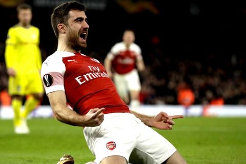Arsenal's Sokratis Papastathopoulos celebrates after scoring his side's third goal during the Europa League round of 32 second leg soccer match between Arsenal and Bate at the Emirates stadium in London, Thursday, Feb. 21, 2019. (AP Photo/Matt Dunham)