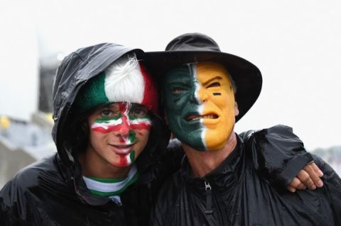 NATAL, BRAZIL - JUNE 13: A pair of Mexico fans brave the rain before the 2014 FIFA World Cup Brazil Group A match between Mexico and Cameroon at Estadio das Dunas on June 13, 2014 in Natal, Brazil.  (Photo by Matthias Hangst/Getty Images)