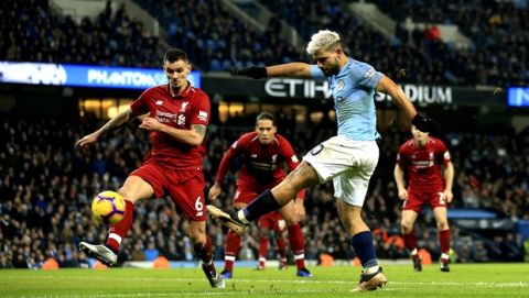 Manchester City's Sergio Aguero, right, shoots and scores the opening goal of the game during their English Premier League soccer match between Manchester City and Liverpool at the Ethiad stadium, Manchester England, Thursday, Jan. 3, 2019. (AP Photo/Jon Super)