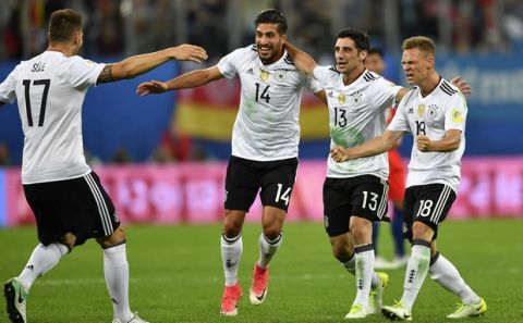 Germany's Niklas Suele, Emre Can, Lars Stindl and Joshua Kimmich, from left, celebrate after winning the Confederations Cup final soccer match between Chile and Germany, at the St.Petersburg Stadium, Russia, Sunday July 2, 2017. (AP Photo/Martin Meissner)