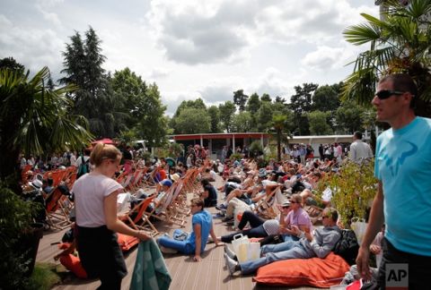 Visitors rest on deck chairs during the French Open tennis tournament at the Roland Garros stadium, Sunday, June 4, 2017 in Paris. (AP Photo/Christophe Ena)
