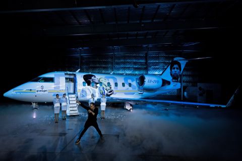 Argentine singer Juan Sebastian Gutierrez, better known as Juanse, performs next to an aircraft called Tango D10S painted with images depicting Argentine late football star Diego Armando Maradona holding the World Cup, during its presentation in Moron, Buenos Aires province, Argentina, on May 25, 2022. - Some of the 1986 FIFA World Cup champions will travel to the Qatar FIFA World Cup on November, 2022 in the Tango D10S to pay homage to Maradona. (Photo by Tomas CUESTA / AFP)