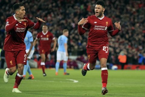 Liverpool's Alex Oxlade-Chamberlain, right, celebrates after scoring his side's second goal of the game during the Champions League quarter final, first leg soccer match between Liverpool and Manchester City at Anfield, Liverpool, England, Wednesday, April 4, 2018. (Peter Byrne/PA via AP)