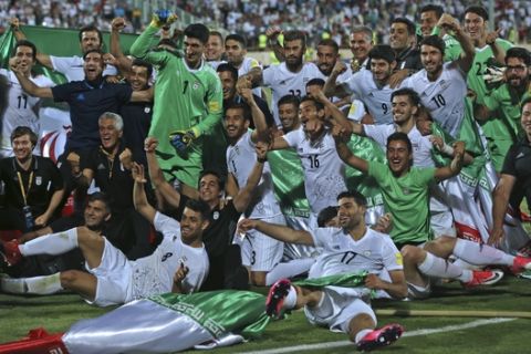Iran national soccer team celebrates after beating Uzbekistan in their Asia Group A, 2018 World Cup qualifying soccer match at the Azadi Stadium in Tehran, Iran, Monday, June 12, 2017. Iran became the second team to qualify for the 2018 World Cup by beating Uzbekistan 2-0. (AP Photo/Vahid Salemi)