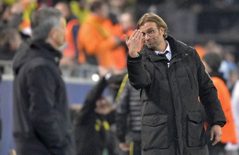 Dortmund head coach Juergen Klopp, right, reacts beside Real's head coach Jose Mourinho, left, during the Champions League Group D soccer match between Borussia Dortmund and Real Madrid in Dortmund, Wednesday, Oct. 24,  2012. (AP Photo / Martin Meissner)