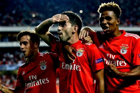 Benfica's Pizzi, center, celebrates scoring his side's first goal from a penalty kick during the Champions League playoffs, first leg, soccer match between Benfica and PAOK at the Luz stadium in Lisbon, Tuesday, Aug. 21, 2018. (AP Photo/Armando Franca)