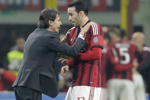 AC Milan coach Filippo Inzaghi, left, gives instructions to AC Milan's Adil Rami during the Serie A soccer match between AC Milan and Inter Milan at the San Siro stadium in Milan, Italy, Sunday, Nov. 23, 2014. (AP Photo/Antonio Calanni)