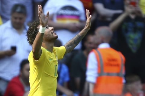 Brazil's Neymar celebrates after scoring his side's opening goal during the friendly soccer match between Brazil and Croatia at Anfield Stadium in Liverpool, England, Sunday, June 3, 2018. (AP Photo/Dave Thompson)