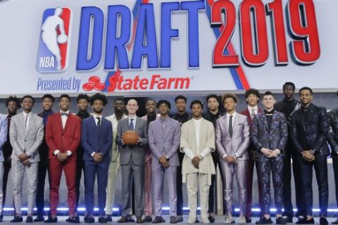 Prospective NBA draft picks pose for a group photo with NBA Commissioner Adam Silver, with basketball, before the NBA draft Thursday, June 20, 2019, in New York. (AP Photo/Julio Cortez)