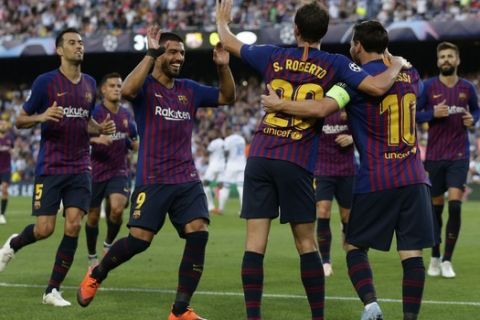 Barcelona players celebrate the opening goal of their team during the group B Champions League soccer match between FC Barcelona and PSV Eindhoven at the Camp Nou stadium in Barcelona, Spain, Tuesday, Sept. 18, 2018. (AP Photo/Manu Fernandez)