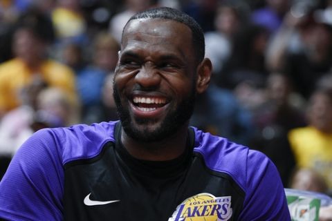 Los Angeles Lakers forward LeBron James reacts while on the bench during the first half of an NBA preseason basketball game against the Los Angeles Clippers in Anaheim, Calif., Saturday, Oct. 6, 2018. (AP Photo/Kelvin Kuo)