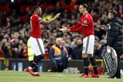 Manchester United's Anthony Martial, left, is substituted off the pitch for Zlatan Ibrahimovic during their English Premier League soccer match against Newcastle United at Old Trafford, Manchester, England, Saturday, Nov. 18, 2017. (Martin Rickett/PA via AP)