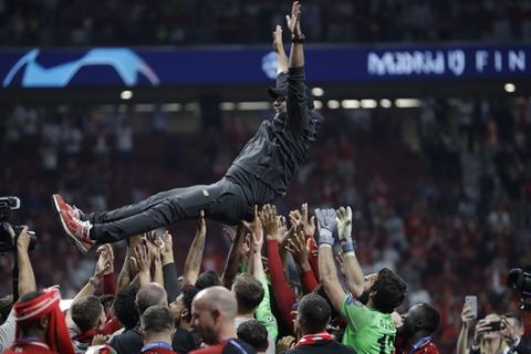 Liverpool's coach Juergen Klopp is tossed by his players as they celebrate for the team's victory end of the Champions League final soccer match between Tottenham Hotspur and Liverpool at the Wanda Metropolitano Stadium in Madrid, Sunday, June 2, 2019. (AP Photo/Felipe Dana)