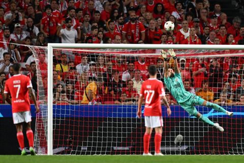 Benfica's Greek goalkeeper Odysseas Vlachodimos dives to make a save during the UEFA Champions League 1st round day 3 group H football match between SL Benfica and Paris Saint-Germain, at the Luz stadium in Lisbon on October 5, 2022. (Photo by PATRICIA DE MELO MOREIRA / AFP)