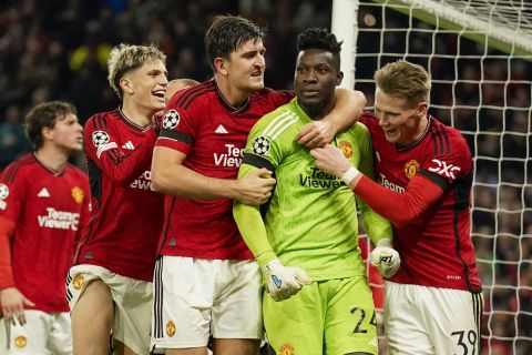 Manchester United's goalkeeper Andre Onana, second right, celebrates with teammates after makes a save penalty shoot during the Champions League group A soccer match between Manchester United and Copenhagen at the Old Trafford stadium in Manchester, England, Tuesday, Oct. 24, 2023. (AP Photo/Dave Thompson)
