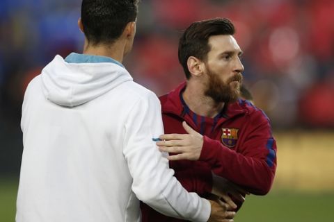 Barcelona's Lionel Messi, right and Real Madrid's Cristiano Ronaldo greets each other before a Spanish La Liga soccer match between Barcelona and Real Madrid, dubbed 'el clasico', at the Camp Nou stadium in Barcelona, Spain, Sunday, May 6, 2018. (AP Photo/Manu Fernandez)