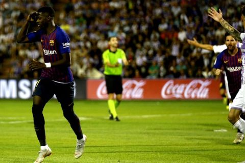 Barcelona's Ousmane Dembele celebrates scoring the opening goal during the Spanish La Liga soccer match between FC Barcelona and Valladolid at the Nuevo Jose Zorrilla stadium in Valladolid, Spain, Saturday, Aug. 25, 2018. (AP Photo/Andrea Comas)