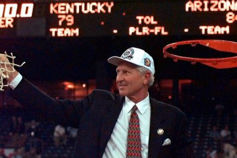 Arizona coach Lute Olson holds up the net for the fans after Arizona beat Kentucky 84-79 in overtime to win the national championship Monday, March 31, 1997,  at the NCAA Final Four tournament in Indianapolis.(AP Photo/Ed Reinke)