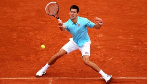 PARIS, FRANCE - MAY 26:  Novak Djokovic of Serbia returns a shot during his men's singles match against Joao Sousa of Portugal on day two of the French Open at Roland Garros on May 26, 2014 in Paris, France.  (Photo by Clive Brunskill/Getty Images)