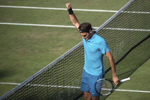 Roger Federer celebrates winning the semifinal tennis match against Nick Kyrgios during the ATP Mercedes Cup in Stuttgart, Saturday June 16, 2018.(Marijan Murat/dpa via AP)