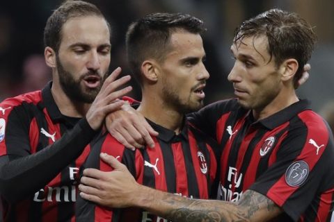 AC Milan's Suso, center, celebrates with his teammates Luca Biglia, right, and Gonzalo Higuain after scoring his side's third goal during the Serie A soccer match between AC Milan and Sampdoria, at the San Siro stadium in Milan, Italy, Sunday, Oct. 28, 2018. (AP Photo/Luca Bruno)