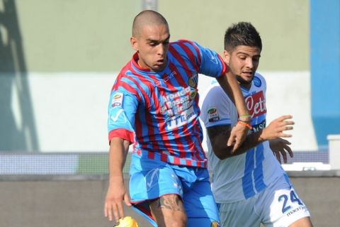 Catania defender Giuseppe Bellusci, left, vies for the ball with Napoli forward Lorenzo Insigne during their Serie A soccer match at the Angelo Massimino stadium in Catania, Italy, Sunday, Sept. 23, 2012. (AP Photo/Carmelo Imbesi)