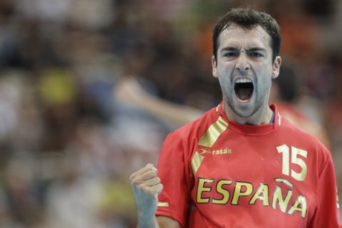 Cristian Ugalde Garcia of Spain celebrates after scoring during their men's handball preliminary match against Serbia at the 2012 Summer Olympics, Sunday, July 29, 2012, in London. (AP Photo/Matthias Schrader)