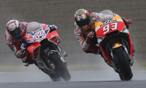 Spain's Marc Marquez steers his Honda tailed by Italy's Andrea Dovizioso on Ducati at the MotoGP Japanese Motorcycle Grand Prix at the Twin Ring Motegi circuit in Motegi, north of Tokyo, Sunday, Oct. 15, 2017. (AP Photo/Shizuo Kambayashi)