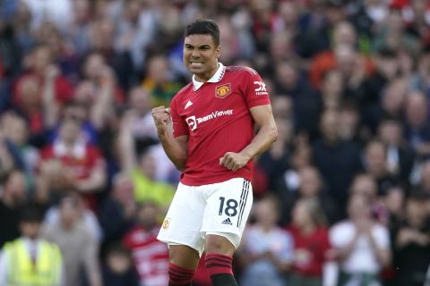Manchester United's Casemiro, right, celebrates after scoring his side's opening goal during the English Premier League soccer match between Manchester United and Chelsea at the Old Trafford stadium in Manchester, England, Thursday, May 25, 2023. (AP Photo/Dave Thompson)