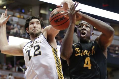 Long Beach State's Temidayo Yussuf, right, gets his shot blocked by UC Irvine's Ioannis Dimakopoulos during the first half of an NCAA college basketball game at the Big West men's tournament Friday, March 10, 2017, in Anaheim, Calif. (AP Photo/Jae C. Hong)