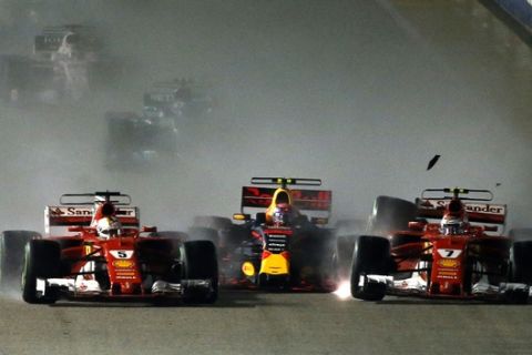 Ferrari driver Kimi Raikkonen, right, of Finland collides with teammate Sebastian Vettel of Germany, left, and Red Bull driver Max Verstappen of the Netherlands at the start of the Singapore Formula One Grand Prix on the Marina Bay City Circuit Singapore, Sunday, Sept. 17, 2017. (AP Photo/Yong Teck Lim)
