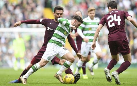 Celtic's Patrick Roberts, center, in action during the Ladbrokes Scottish Premiership match at Celtic Park, Glasgow, Scotland, Sunday, May 21, 2017. Celtic became the first team in 118 years to complete a season undefeated in Scotlands top division by beating Hearts 2-0 on Sunday. (Craig Watson/PA via AP)