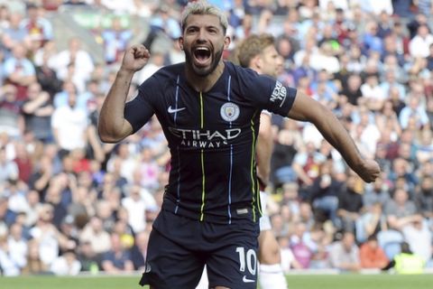 Manchester City's Sergio Aguero, left, celebrates after scoring his side's opening goal during the English Premier League soccer match between Burnley and Manchester City at Turf Moor in Burnley, England, Sunday, April 28, 2019. (AP Photo/Rui Vieira)