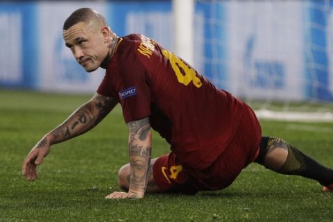 Roma's Radja Nainggolan lies on the pitch as Shakhtar's Yaroslav Rakytskyy stands behind, during a Champions League round of 16 second-leg soccer match between Roma and Shakhtar Donetsk, at the Rome Olympic stadium, Tuesday, March 13, 2018. (AP Photo/Gregorio Borgia)
