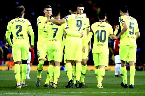 Barcelona players celebrate the opening goal of their team during the Champions League quarterfinal, first leg, soccer match between Manchester United and FC Barcelona at Old Trafford stadium in Manchester, England, Wednesday, April 10, 2019. (AP Photo/Jon Super)