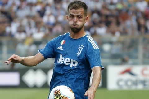 Juventus' Miralem Pjanic controls the ball during the Serie A soccer match between Parma and Juventus at the Tardini stadium, in Parma, Italy, Saturday, Aug. 24, 2019. (AP Photo/Antonio Calanni)