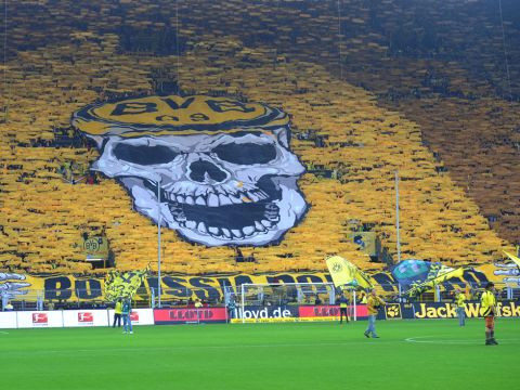 Dortmund supporters show a big display with a skull on it before the German first division Bundesliga football match Borussia Dortmund vs VfL Wolfsburg in the western German city of Dortmund on November 5, 2011. AFP PHOTO / PATRIK STOLLARZ

 +++ RESTRICTIONS / EMBARGO - DFL LIMITS THE USE OF IMAGES ON THE INTERNET TO 15 PICTURES (NO VIDEO-LIKE SEQUENCES) DURING THE MATCH AND PROHIBITS MOBILE (MMS) USE DURING AND FOR FURTHER TWO HOURS AFTER THE MATCH. FOR MORE INFORMATION CONTACT DFL. (Photo credit should read PATRIK STOLLARZ/AFP/Getty Images)