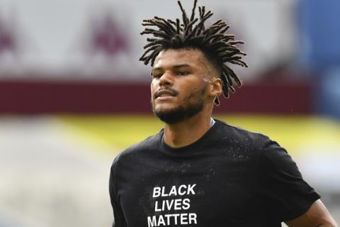 Aston Villa's Tyrone Mings warms up prior to the start of the English Premier League soccer match between Aston Villa and Sheffield United at Villa Park in Birmingham, England, Wednesday, June 17, 2020. The English Premier League resumes Wednesday after its three-month suspension because of the coronavirus outbreak. (Paul Ellis/Pool via AP)