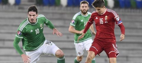 Northern Ireland's striker Kyle Lafferty (L) vies with Hungary's midfielder Adam Nagy during the Euro 2016 qualifying group F football match between Northern Ireland and Hungary at Windsor Park in Belfast on September 7, 2015. AFP PHOTO / MICHAEL COOPER        (Photo credit should read Michael Cooper/AFP/Getty Images)