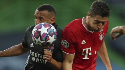 Lyon's Lucas Tousart, left, and Bayern's Robert Lewandowski go for the ball during the Champions League semifinal soccer match between Lyon and Bayern Munich at the Jose Alvalade stadium in Lisbon, Portugal, Wednesday, Aug. 19, 2020. (Miguel A. Lopes/Pool via AP)