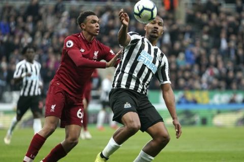 Liverpool's Trent Alexander-Arnold, left, and Newcastle United's Salomon Rondon battle for the ball during the English Premier League soccer match at St James' Park, Newcastle, England, Saturday May 4, 2019. (Owen Humphreys/PA via AP)
